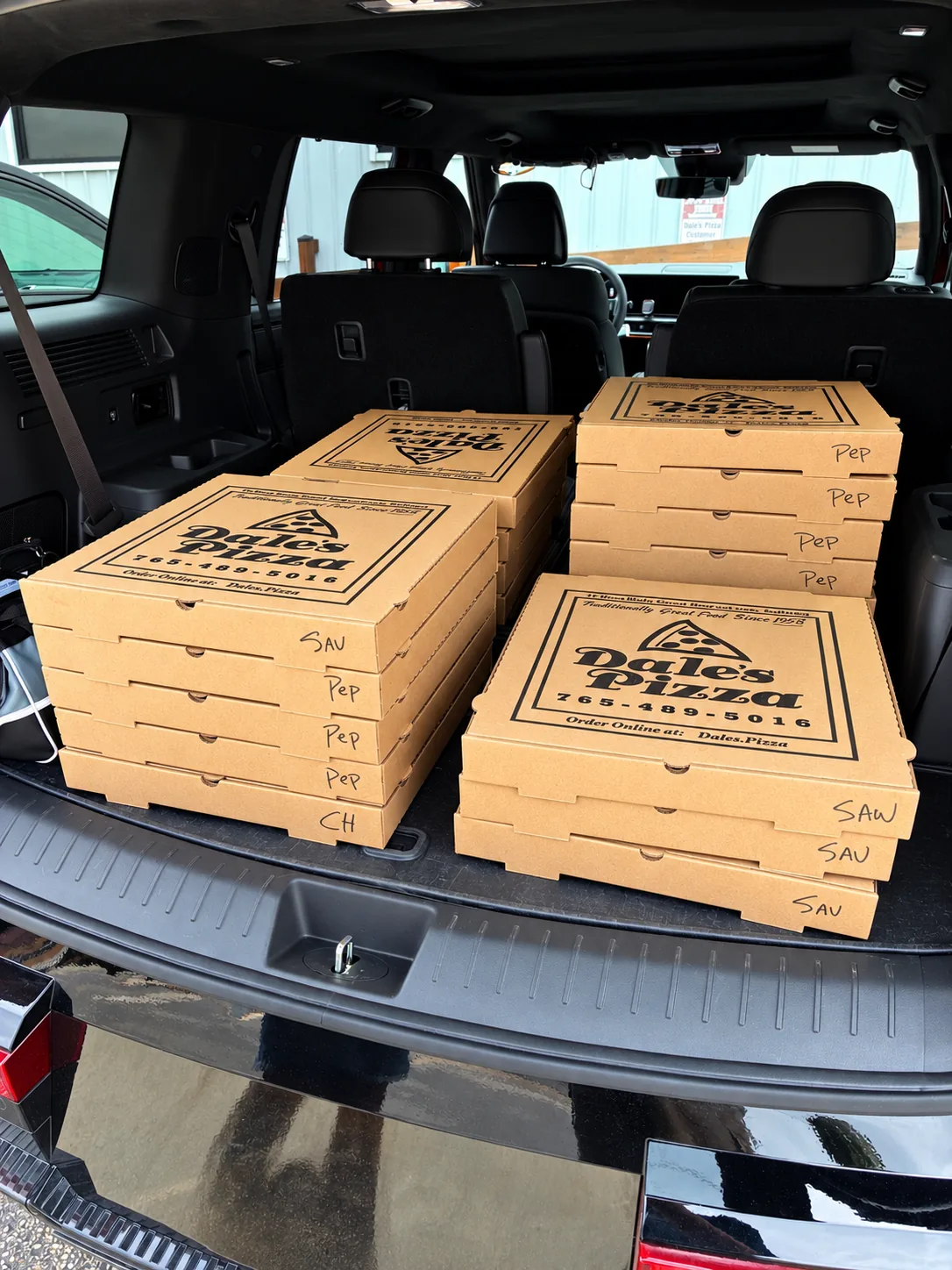 A large Dale's Pizza order packed for an event